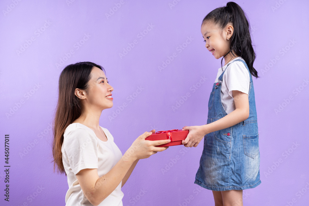 Portrait of Asian mother and daughter on purple background Portrait of Asian mother and daughter on purple background