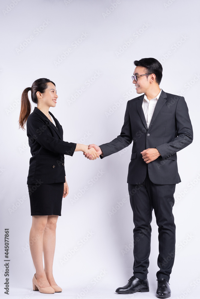 Asian businessman and businesswoman shaking hand on white background Asian businessman and businesswoman shaking hand on white background