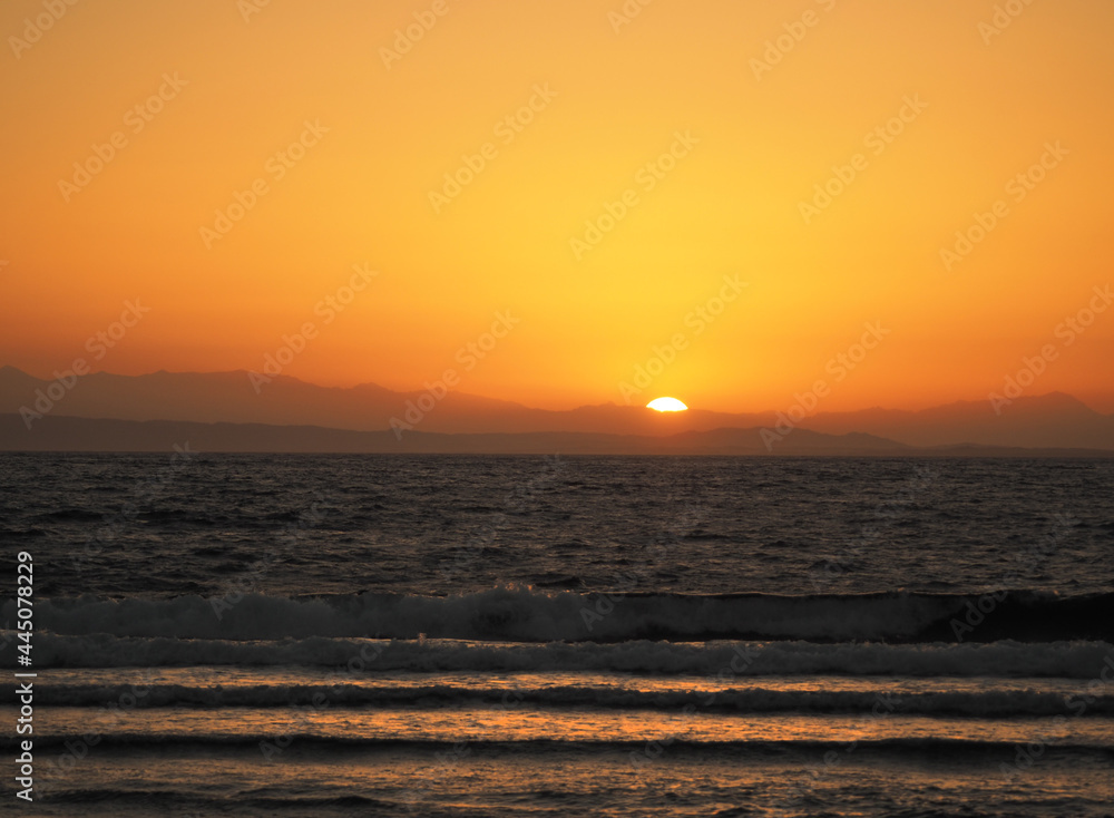 Bright sunrise with large yellow sun in Arabian Gulf
