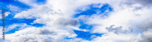 Bright blue sky with scattered white clouds panorama © Xookits