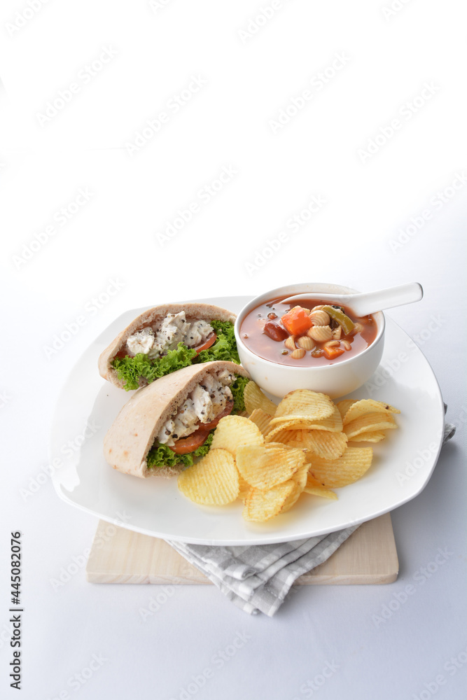 chicken salad kebab open pocket bread serve with tomato soup and crispy potato chips combo set  in white background asian vegan halal menu