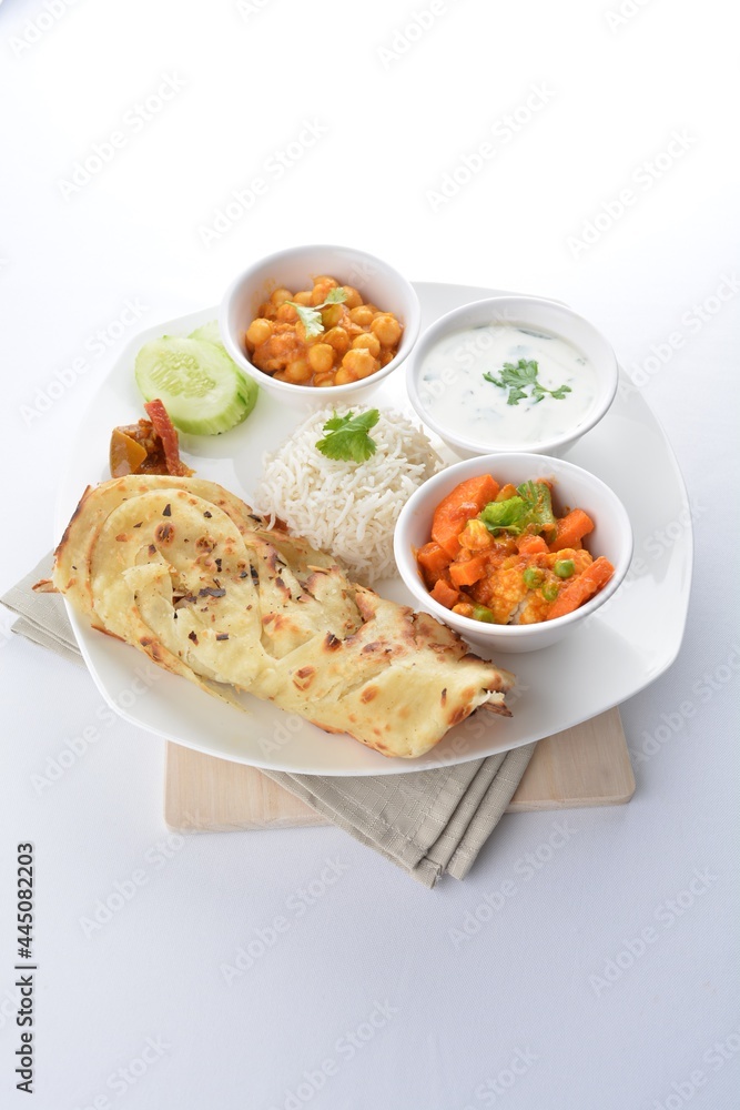 Indian baked roti prata canai with curry vegetables, yogurt sauce, pea