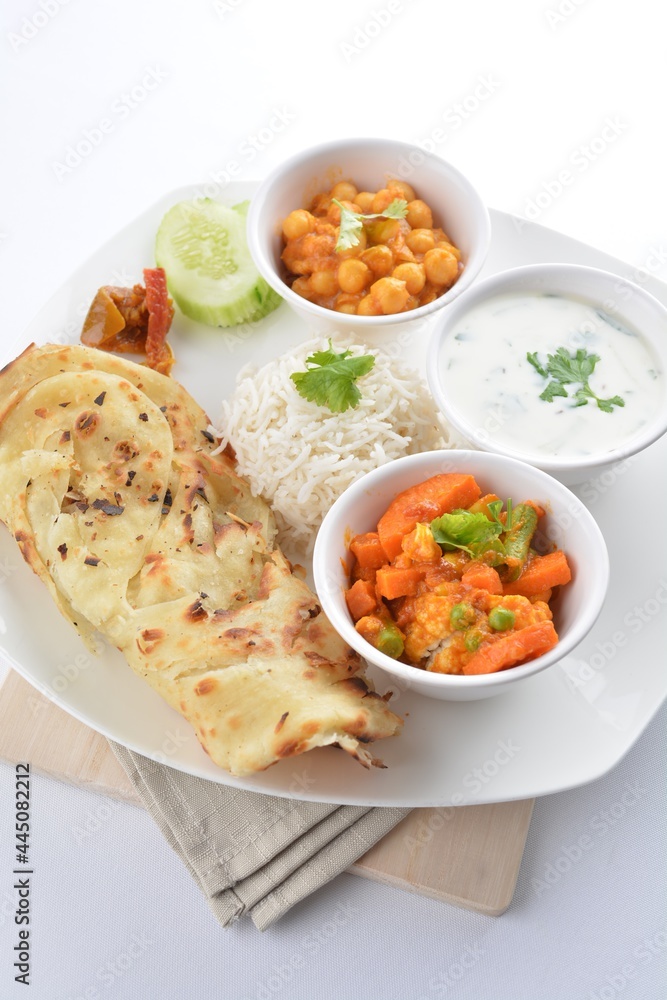 Indian baked roti prata canai with curry vegetables, yogurt sauce, pea