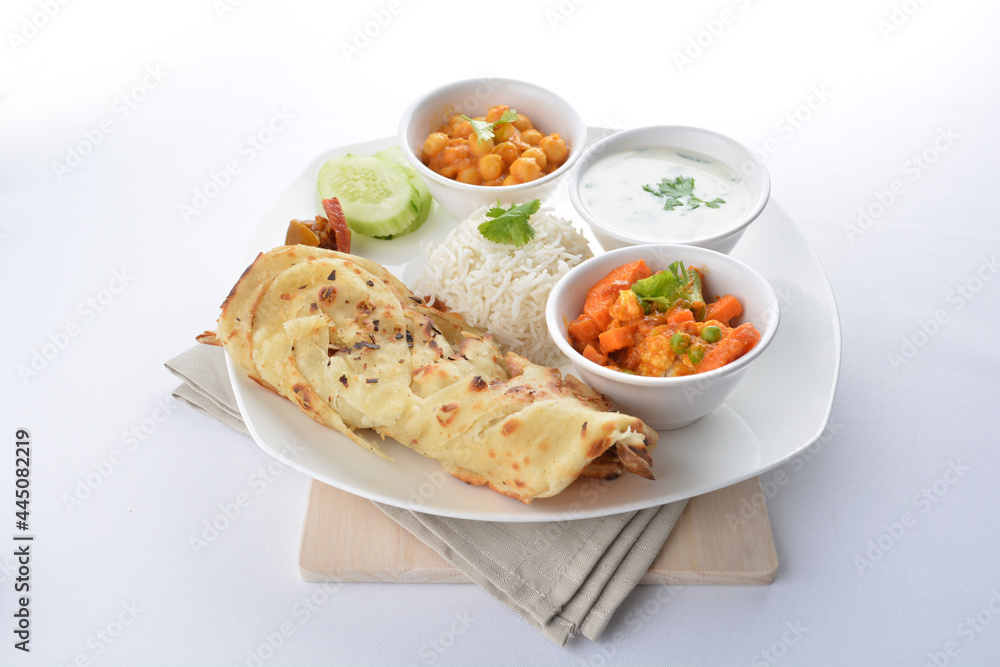 Indian baked roti prata canai with curry vegetables, yogurt sauce, pea