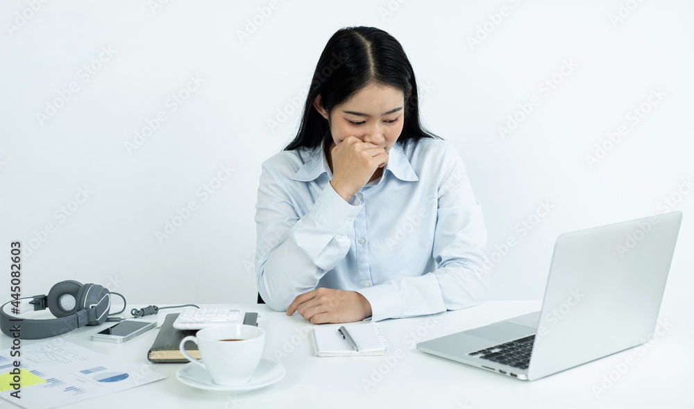 Working Asian women feel stressed, dismal tired from work, migraine headaches from hard work while working at the office Working Asian women feel stressed, dismal tired from work, migraine headaches from hard work while working at the office