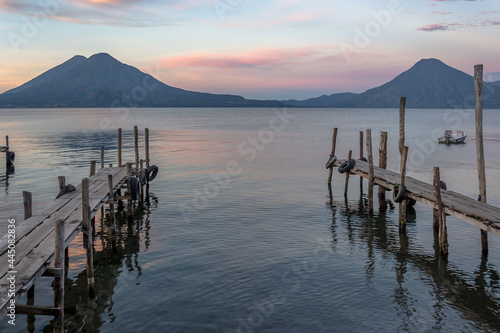 Spectacular landscape of a lonely boat at sunrise - Panajachel, Lake Atitlán, in the Guatemalan highlands, Central America photo