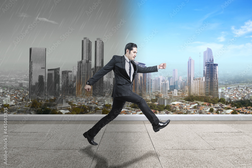 Asian businessman running to different climates Asian businessman running to different climates