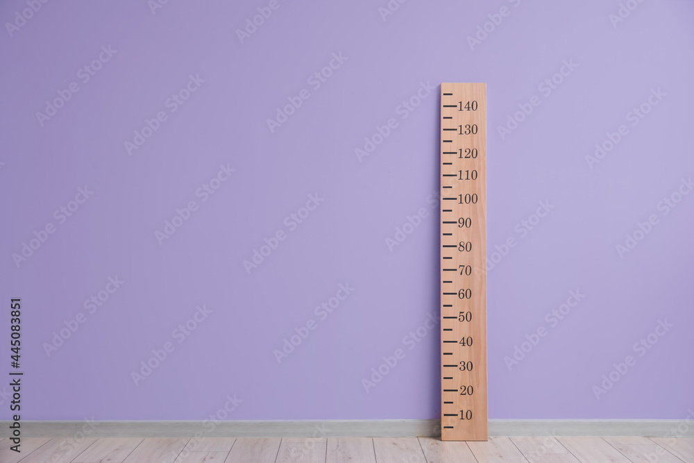 Big ruler for height measuring near color wall - obrazy, fototapety, plakaty 