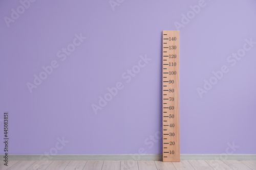 Big ruler for height measuring near color wall