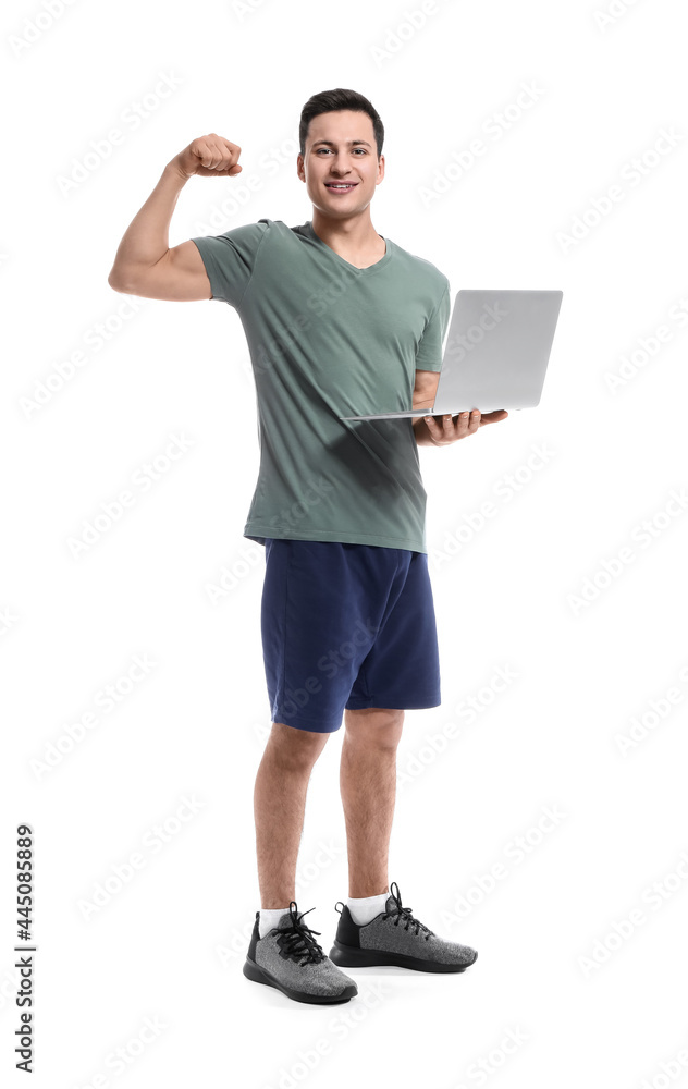 Sporty male coach with laptop on white background