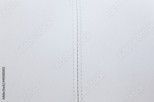 Bilde på lerret Two pieces of white canvas fabric sewn in the middle with a straight seam of white thread