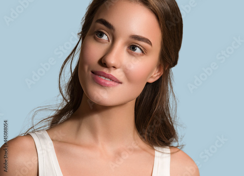 Beauty woman face natural make up healthy skin over color background photo