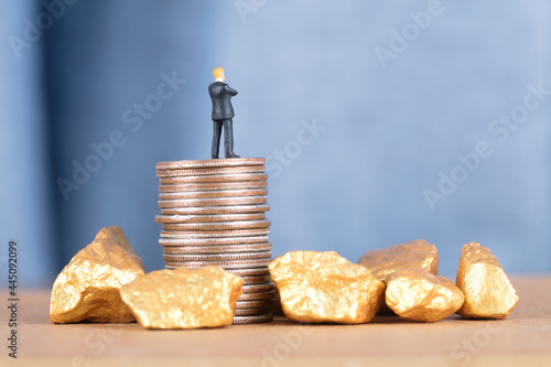 The businessman on the coin and the gold underneath