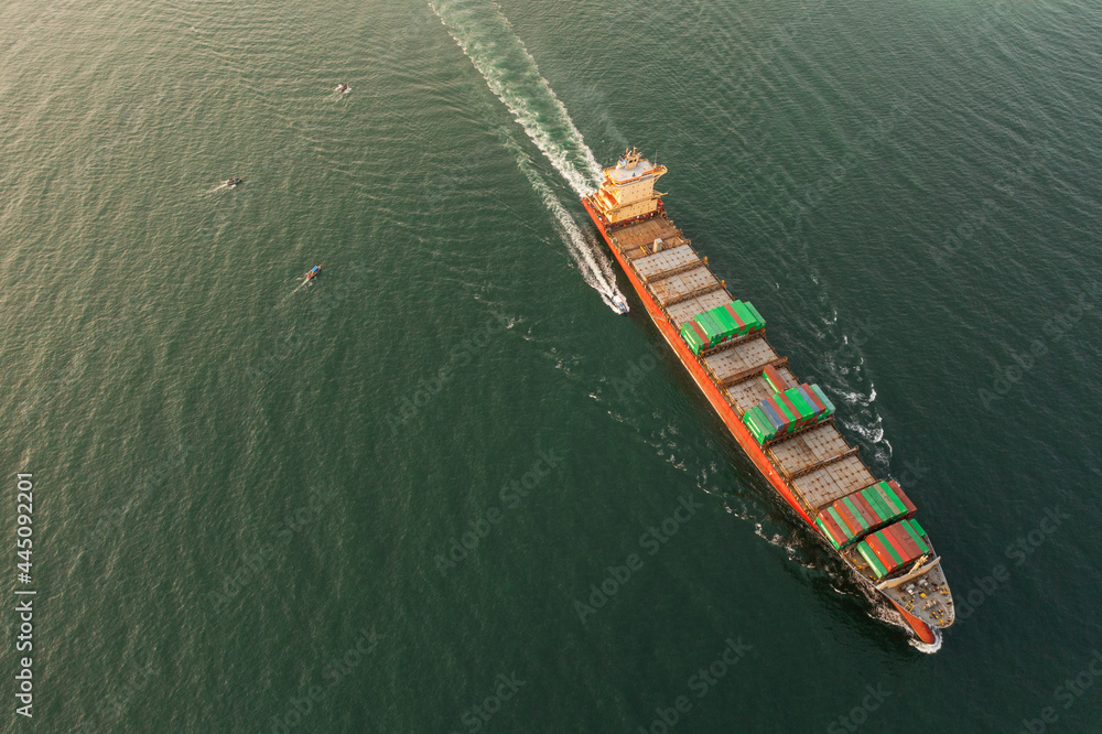 Container ship in export and import business and logistics. Shipping cargo to harbor Water transport International. Aerial view and top view.