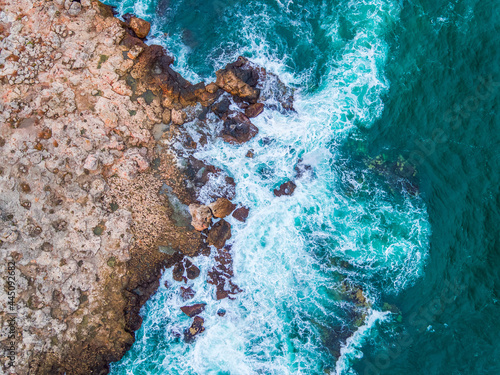 Aerial view of rocky coastline and crashing waves