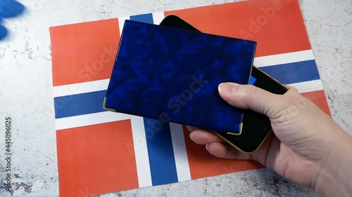 Vaccination passport in hands allowing movement and travel in Norway. Vaccination against the coronavirus Covid -19. Imunity passport. health passport. Top View, closeup photo