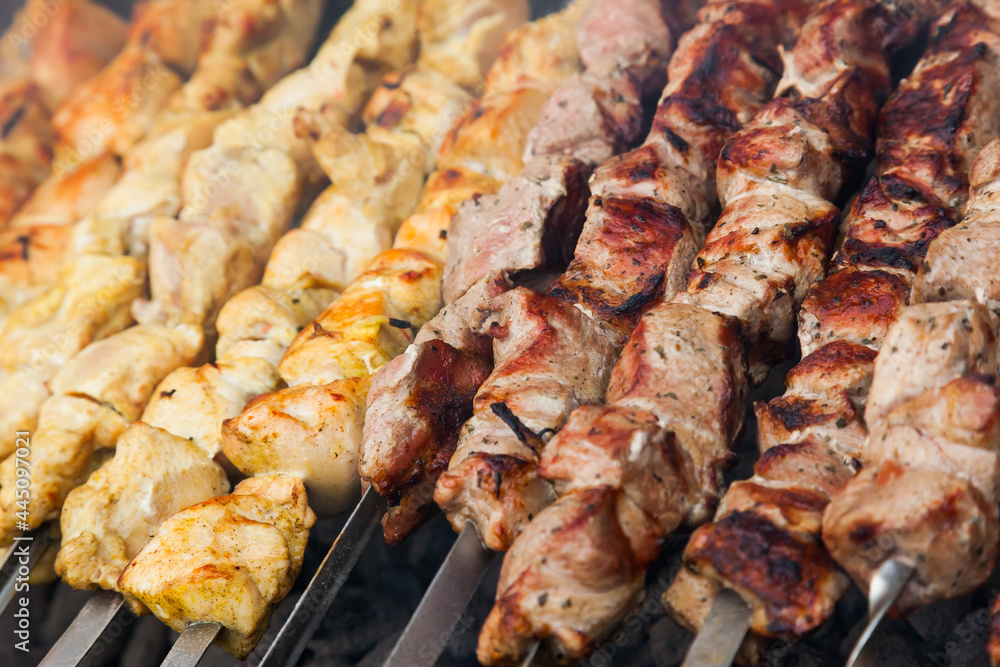 Background of chicken and lamb cut into pieces and fried on the grill. Fried kebab background with chicken and lamb.