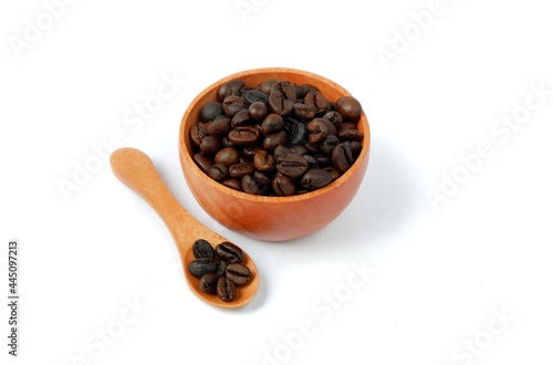 Coffee beans with wooden bowl and wooden spoon isolated on white background