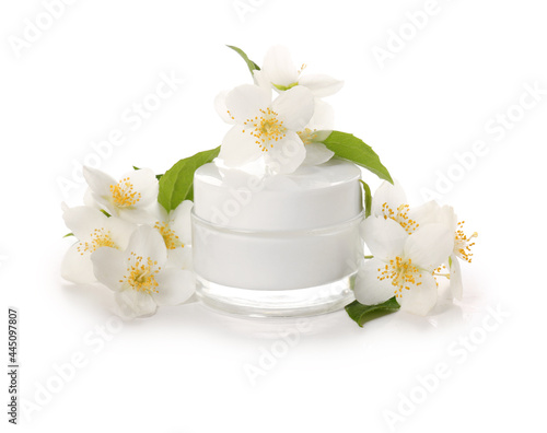 Jar of cream and jasmine flowers on white background