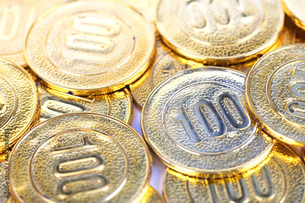 Close-up of gold coins scattered all over the place Close-up of gold coins scattered all over the place