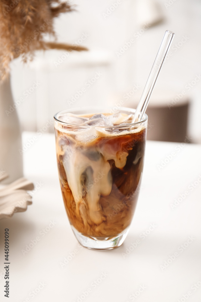 Glass of tasty ice coffee with milk on table - obrazy, fototapety, plakaty 