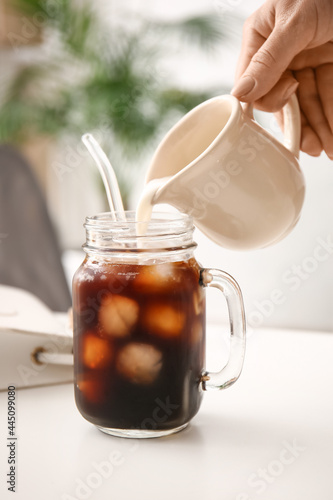 Woman pouring milk from jug...