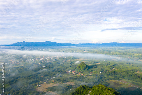 Panorama Aerial view Drone shot of Beautiful scenery landscape sunlight in the morning sunrise above flowing fog waves on mountain peak  
