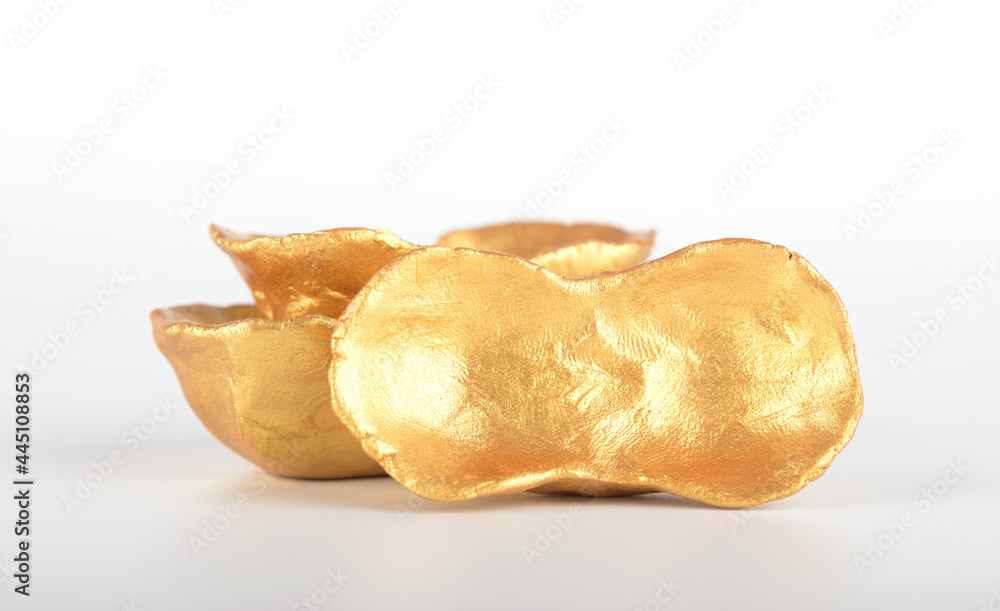 Golden gold ingot on white background