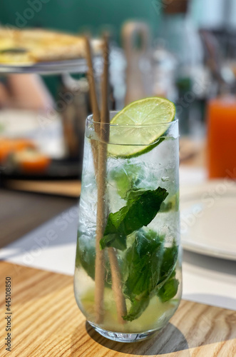 Mojito cocktail with lime and mint in glass