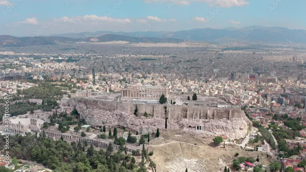 Aerial shot of the Acropolis in the center of Athens Greece. Ancient ruins with columns on the mountain, panorama of the city with streets and houses. Aerial shot of the Acropolis in the center of Athens Greece. Ancient ruins with columns on the mountain, panorama of the city with streets and houses.