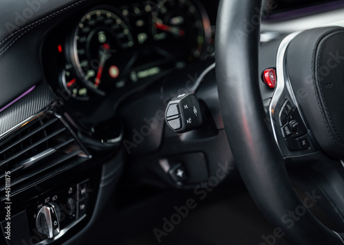 Modern sports car Interior, travel concept. Car dashboard. Focus on headlight knob in the car