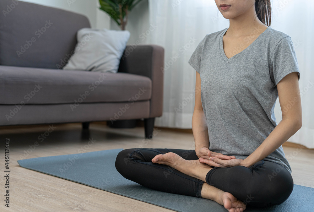 Young beautiful woman practicing yoga at home. Young beautiful girl doing exercises at home. balance, meditation, relaxation, healthy lifestyle concept Young beautiful woman practicing yoga at home. Young beautiful girl doing exercises at home. balance, meditation, relaxation, healthy lifestyle concept