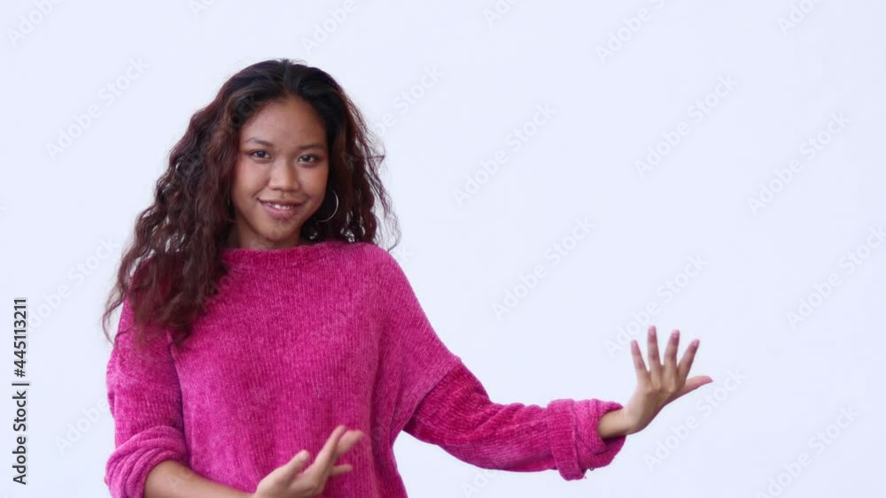 Look at the product on my hand! Cheerful girl pointing at advertising area, showing empty place for commercial image, promotional text. studio shot isolated on white background. Look at the product on my hand! Cheerful girl pointing at advertising area, showing empty place for commercial image, promotional text. studio shot isolated on white background.