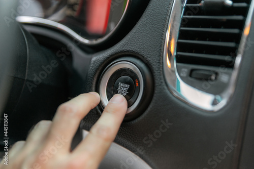 Male's finger pressing the start button, stop the engine in the luxury car © Oleksandr