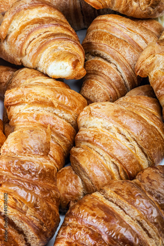 freshly baked croissants are laid out on the counter of the confectionery