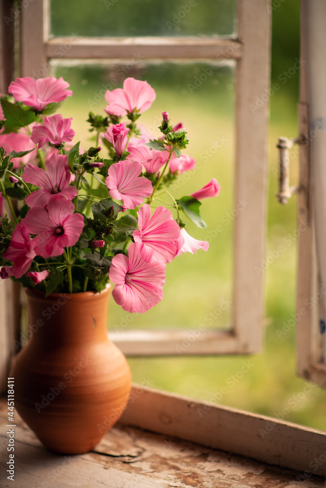 Fototapeta premium Still-life. A bouquet of pink flowers on the window.