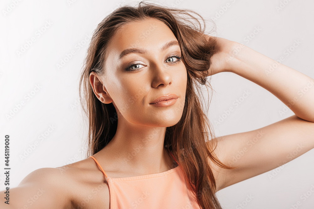 Beautiful young girl smiling and posing looking at the camera on a white isolated background. Positive brunette woman. Kind look. Beauty face Beautiful young girl smiling and posing looking at the camera on a white isolated background. Positive brunette woman. Kind look. Beauty face