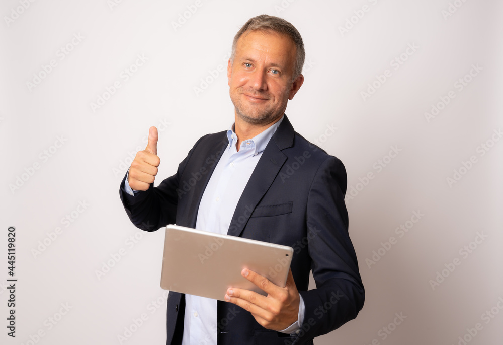 Happy young businessman using digital tablet isolated on white background Happy young businessman using digital tablet isolated on white background