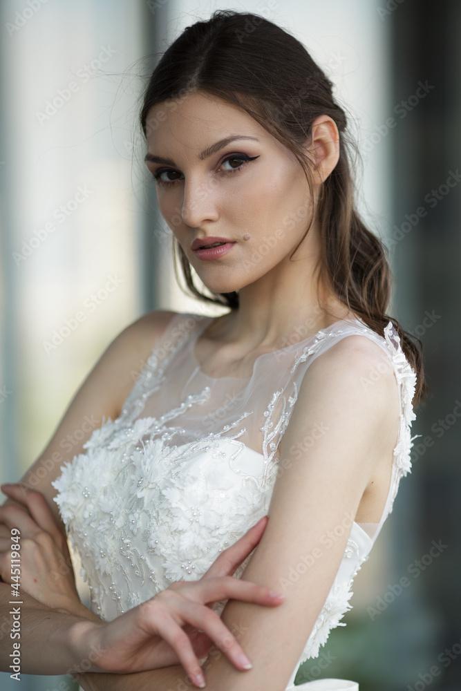 beautiful woman in white long dress posing in the city beautiful woman in white long dress posing in the city