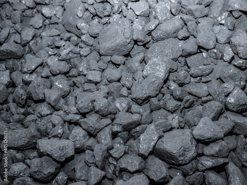 A large pile of carbon stones piled up for subsequent combustion, forming an energetic background of this precious mineral used in homes for combustion and producing heat energy to heat the home photo