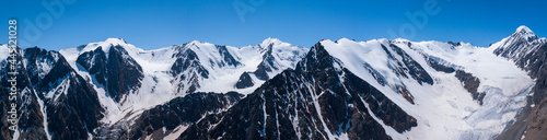Panoramic view of the Aktru glacier, rugged rocky mountains with snowy slopes and Aktru peak 4044, Altai photo by drone