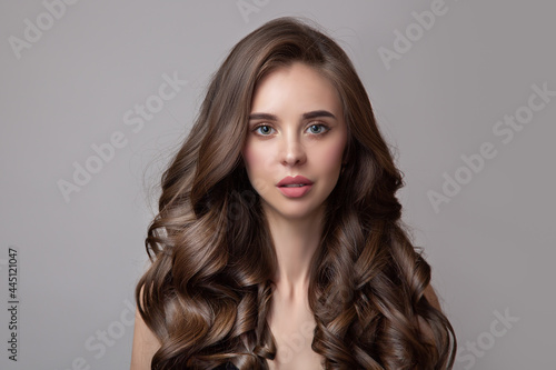 portrait of a beautiful woman with large curls and dark brown hair