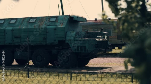 Mobile military armored vehicles stand in a column. The cars have different purposes - a combat control automobile, a combat control engine, a communication apparatus. Heavy artillery. Combat vehicles