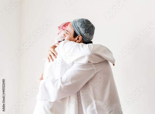 Muslim men hugging each other photo