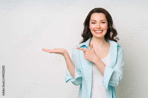 Photography Young woman smiling and gesturing to copy space.