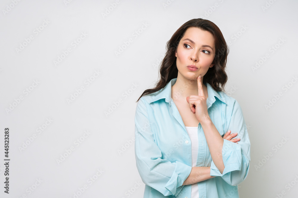 Portrait of a thoughtful young woman solving a difficult problem Portrait of a thoughtful young woman solving a difficult problem