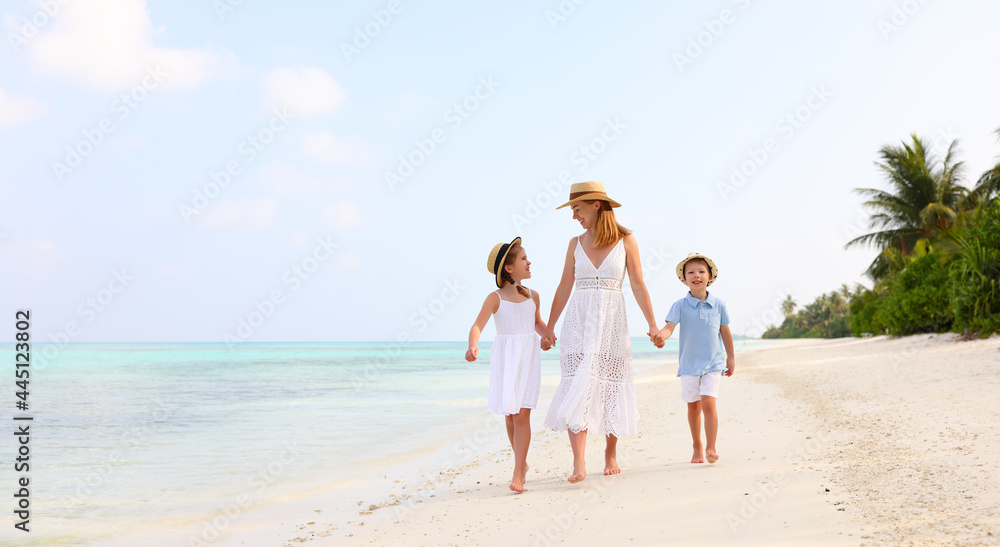 Mother with children walking on beach Mother with children walking on beach