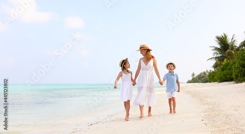 Mother with children walking on beach