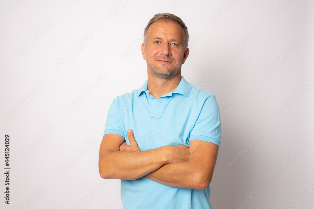 Handsome young man smiling with arms crossed on white background Handsome young man smiling with arms crossed on white background