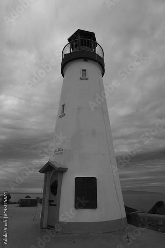 Grayscale shot of the Walton Lighthouse on the shore under a cloudy sky in Santa Cruz, California